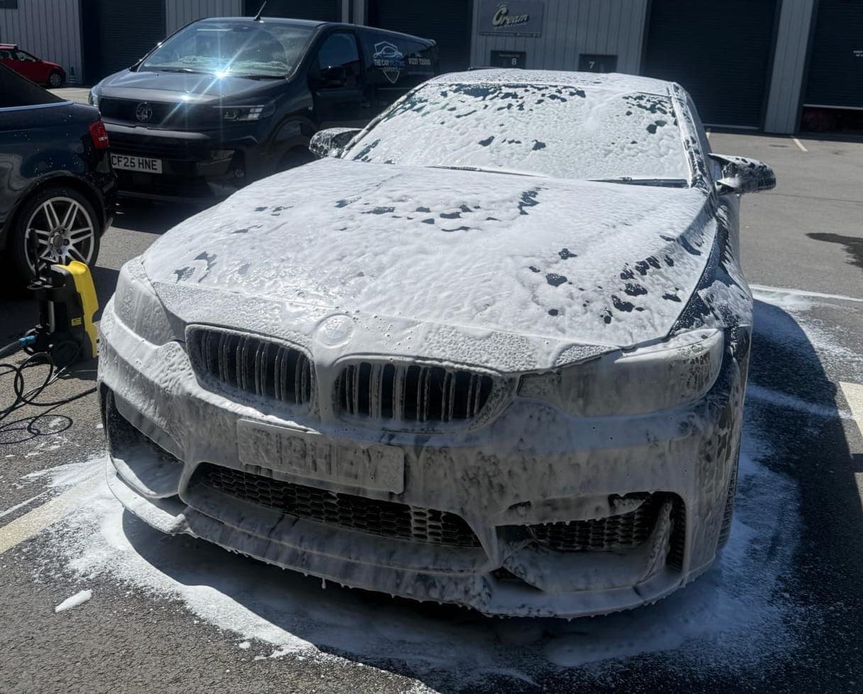 BMW covered in snow foam during a pre-wash